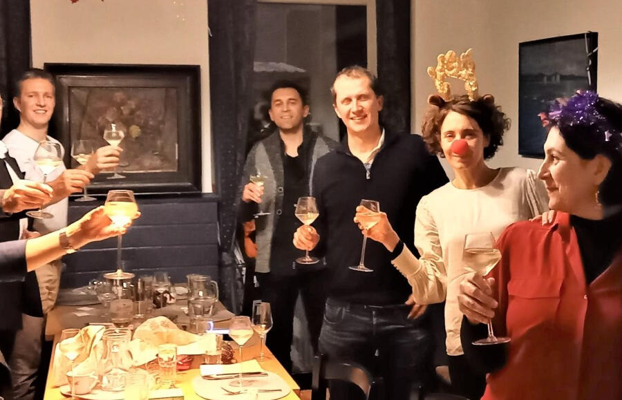 a group of people standing and holding glasses