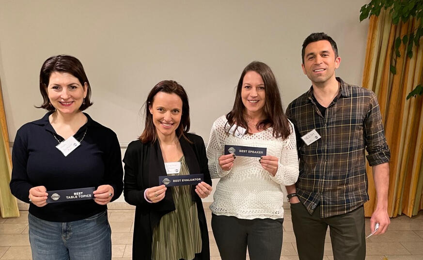 people holding winners badges in their hands